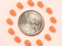 100 perles en plastique rondes 6 mm - orange fluo